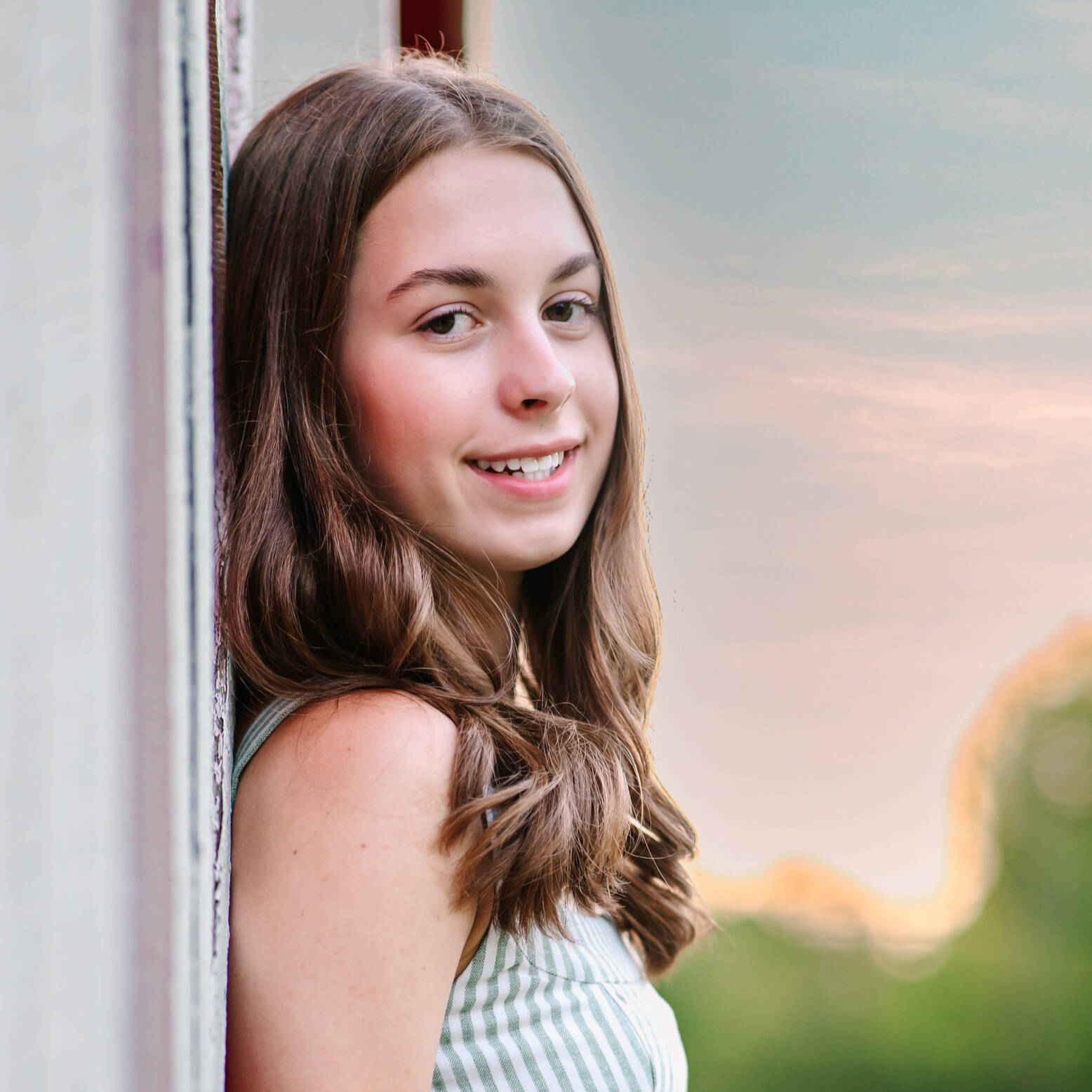 Young woman with brown hair against a blurred background